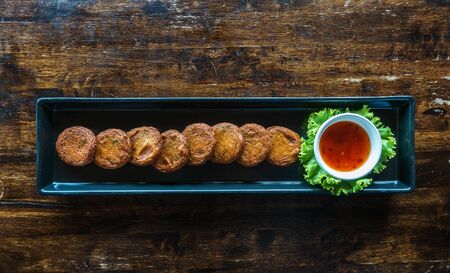 Thai Food Curried fish cake. Fish Cake (Tod Mun Pla) on wooden table.の写真素材