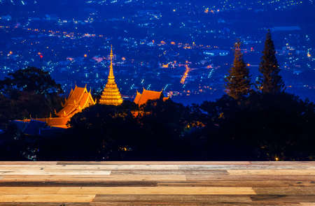 Wood floor with night landscape of Wat phra that Doi Suthep, Landmark of Chiang Mai, Thailand.の写真素材