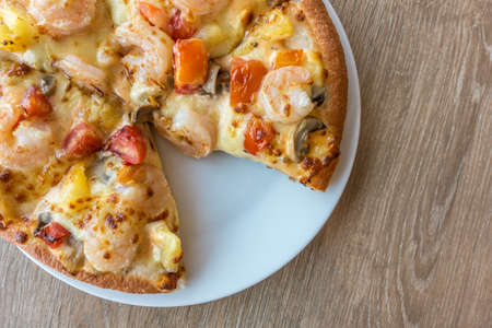 Delicious italian pizza served on wooden tableの写真素材