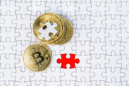 Gold bitcoin on white jigsaw or puzzle, cryptocurrency. Missing jigsaw puzzle pieces. Business solution concept, Key for success concept. Completing finance concept.の写真素材