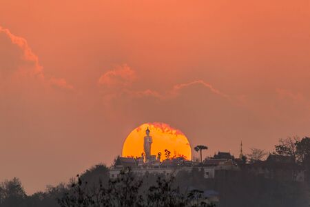 Sunset on Buddha statue of Wat Phra That Doi Kham Temple, Chiang Mai, Thailand. The Temple in Thailand are public image.の写真素材