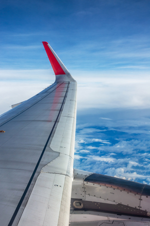 Wing of an airplane flying above the clouds.の写真素材