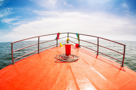 Head of wooden boat running to the sea, Boat bow sailing in blue sea in summer vacation.の写真素材