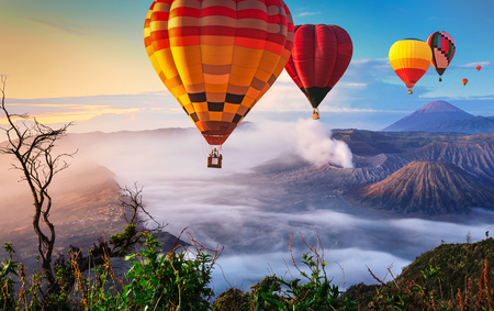 Colorful hot air balloons flying over Mount Bromo, Java, Indonesia.の写真素材