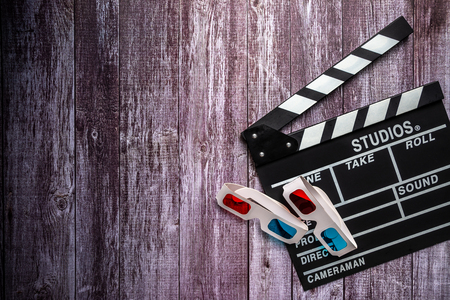Clapperboard and 3d glasses on wooden background.mock up, top view. Flat lay of cinema items.