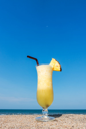 Pineapple smoothies on tropical background, Fruit cocktails on paradise beach.の写真素材