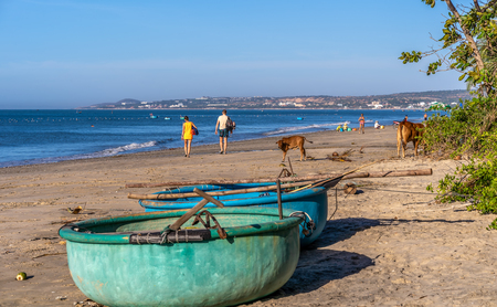 Unidentified tourists are traveling fishing village and looking for a Vietnamese fishing boat at the village, Binh Thuan, South of Vietnam.の写真素材