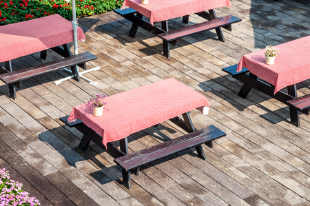 Empty table and red tablecloth in outdoor party or picnic in the garden for summer seasonの写真素材
