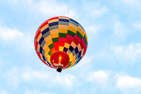 Colorful hot air balloons floating above the lake with blue sky in Chiang Rai, Thailandの写真素材