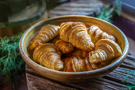 Fresh croissants on wooden tableの写真素材