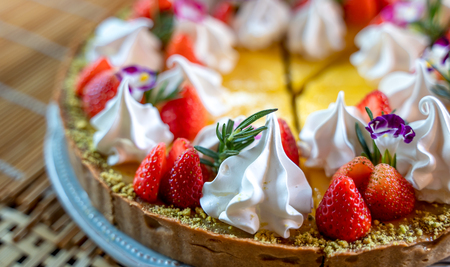 Delicious lemon tarts and garnished with strawberry, cooking dessert.の写真素材