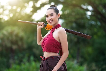 Asian woman warrior in Ayutthaya costume holding sword fight. Warrior woman of soldier of Bang Rachan in Thailand.の写真素材