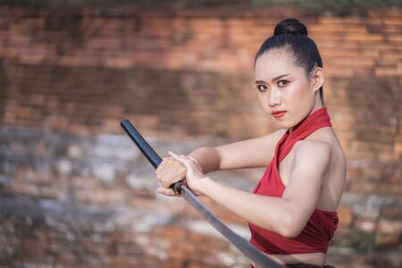 Asian woman warrior in Ayutthaya costume holding sword fight. Warrior woman of soldier of Bang...