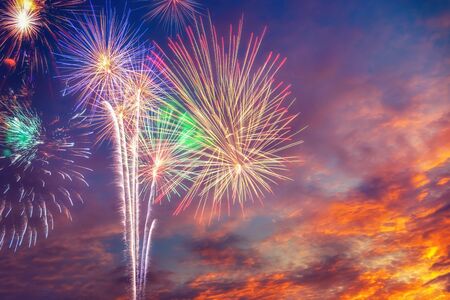 Beautiful colourful majestic fireworks in the twilight sky and clouds.の写真素材
