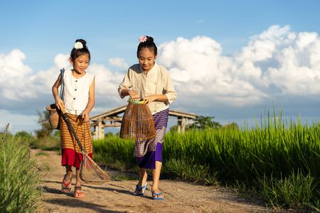 Asian children in rice fields with countryside backgroundの写真素材