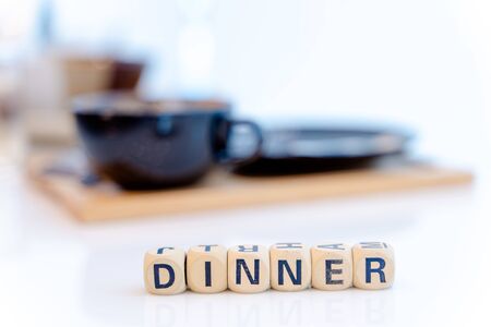 DINNER word written on wood cubes on table.の写真素材