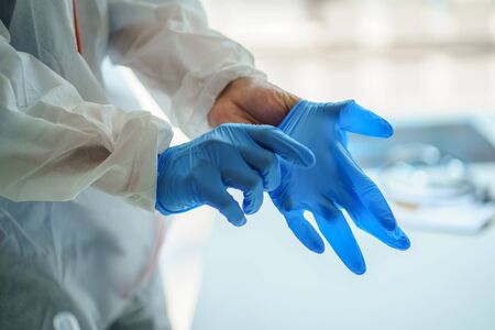 Male doctor wears medical gloves for Protective Epidemic Coronavirus, Covid-19 outbreak concept