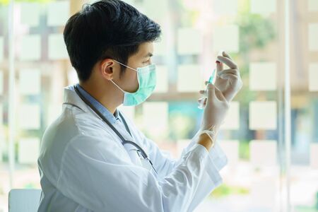 Doctor holding Syringe injection and Vaccine, Prevention, immunization and treatment from corona...