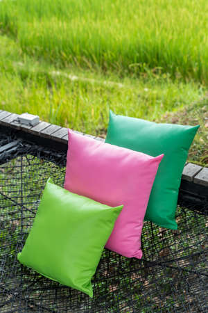 Comfortable colorful pillows lay on rope netting in garden for resting and relaxation.の写真素材