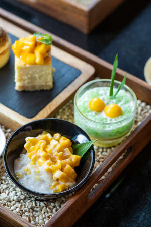 Many kinds of sweets made from mango, sweet thai dessert cuisine made from sticky rice, mango, coconut, Sliced mango with sweet and salty sauce that made of tiny shrimp with fish sauce and sugar, traditional Thai food for snackの写真素材