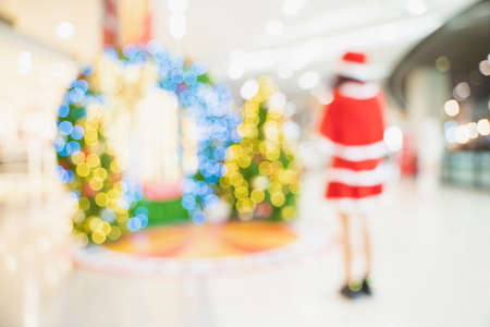 Blur Santa woman, woman in Santa Claus costume and Christmas tree in Merry Christmas xmas indoorsの写真素材