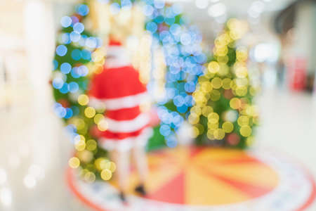 Blur Santa woman, woman in Santa Claus costume and Christmas tree in Merry Christmas xmas indoorsの写真素材
