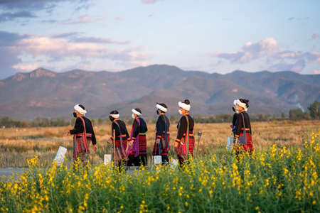 Lamphun, Thailand - January 21, 2022 : Elders and children of Tailue people dress up in traditional costumes to perform at community events.のeditorial素材