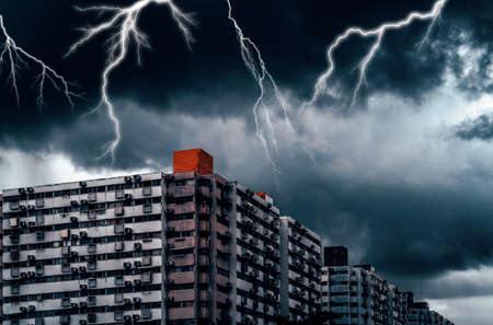Lightning storm over the old residential area, Old apartment with dark sky and lightning.の写真素材