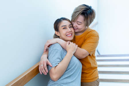 LGBT Lesbian couple love moments happiness concept. Two LGBTQ lesbian friends hugging each other at home. Happy and Friendship concept.の写真素材