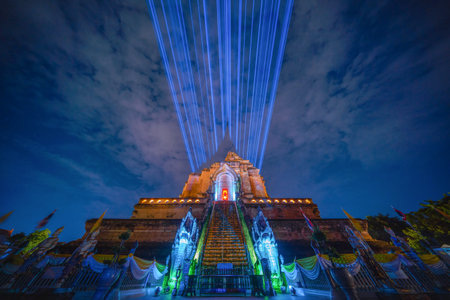 Temple in night, Wat Chedi Luang with laser lights show the lost pagoda from the collapse, Chiang Mai, Thailand. skyline,Old temple area at night.のeditorial素材
