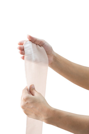 Closed up woman hands putting bandage on white backgroundの写真素材