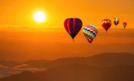 color hot air balloon in sky at sunrise time, Colorful hot-air balloons flying in orange sky and sunset. Sport, adventure, transportation,Travel.の写真素材