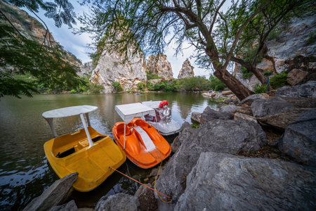 Colorful boats on the lake at Hin Khao Ngu Park, Khao Ngu Stone Park in Ratchaburi, Thailand also call Snake Mountain. Beautiful stone mountain and lake in Ratchaburi Provinceの写真素材