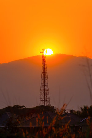 Telephone tower, radio tower during sunset. Telecommunication Tower for 2G 3G 4G 5G network, Cellular phone antenna, BTS, microwave, repeater, base station, IOT.の写真素材