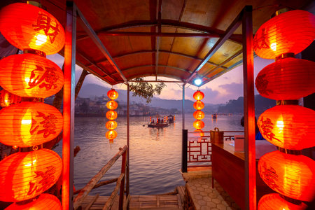 The Pier for tourists to ride chiness boats on the lake at Ban Rak Thai village, Mae Hong Son province, Thailand. Chinese characters on red lantern - Translated text means happy, lucky, wealthyの写真素材