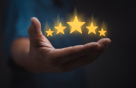 hand of customer or client holding the stars to complete five stars. with copy space. giving a five star rating. Service rating, satisfaction concept,excellent evaluate after customer use productの写真素材