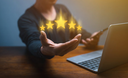 hand of customer or client holding the stars to complete five stars. with copy space. giving a five star rating. Service rating, satisfaction concept,excellent evaluate after customer use productの写真素材