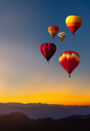 Colorful hot air balloon is flying at sunrise and sunset, hot air balloon Landscape at Sunrise. Travel, inspiration, success, dream, flight and freedom conceptの写真素材