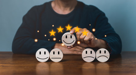 customer services best excellent business rating experience. Satisfaction survey concept. Hand of a businessman chooses a smile face on wood block circle. 5 Star Satisfactionの写真素材