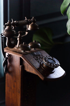 Closeup of a brass antique dial telephone in vintage room. Vintage or antique telephoneの写真素材