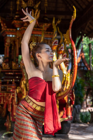 Thailand traditional or cultural dance in Thai costume. The beautiful girl is dancing called Nang Ram, it is noble art of elegance. Thai dancing girl with Siam royal Chariot backgroundの写真素材