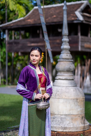 Beautiful Asian women wearing in Thai dress costume traditional according Thai culture and tradition at the ancient wooden temple Chiang Mai, Thailand.Portrait asian Model with smilingの写真素材