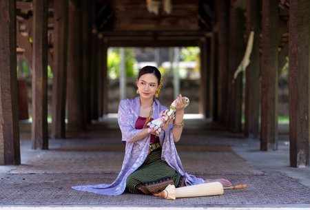 Beautiful Asian women wearing in Thai dress costume traditional according Thai culture and tradition at the ancient wooden temple Chiang Mai, Thailand.Portrait asian Model with smilingの写真素材