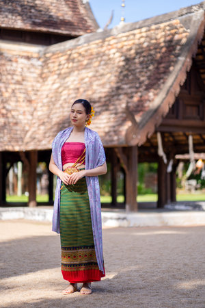 Beautiful Asian women wearing in Thai dress costume traditional according Thai culture and tradition at the ancient wooden temple Chiang Mai, Thailand.Portrait asian Model with smilingの写真素材