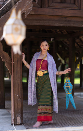 Beautiful Asian women wearing in Thai dress costume traditional according Thai culture and tradition at the ancient wooden temple Chiang Mai, Thailand.Portrait asian Model with smilingの写真素材