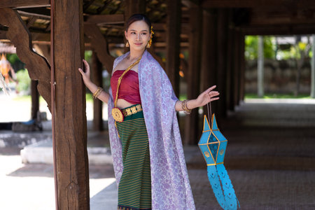 Beautiful Asian women wearing in Thai dress costume traditional according Thai culture and tradition at the ancient wooden temple Chiang Mai, Thailand.Portrait asian Model with smilingの写真素材