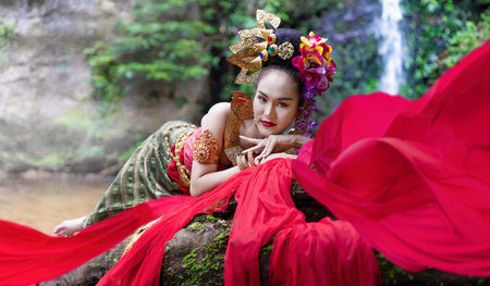 Chiang Mai, Thailand - June 24, 2023 : Beautiful Thai young woman portrait dressed in PhraPuen PhraPaeng traditional Thai dress. According to her concept in the literature of ancient Thailand.のeditorial素材