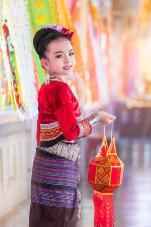Chiang Mai, Thailand - December 18, 2018 : A little girl Asian woman in Thai Lanna traditional dress holding a paper lantern and perform during Yi Peng festival ceremony in Chiang Mai, Thailand.のeditorial素材