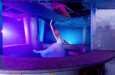 Ballet. Ballerina dancing on the dark room with colorful light. Young graceful woman ballet dancer demonstrating dancing skill. Beauty of classic ballet in Chiang Mai, Thailand - April 10, 2023のeditorial素材