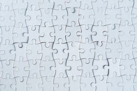 Jigsaw puzzle white color, Puzzle pieces grid, Success mosaic solution template, Horizontal on white background copy space for text, Top view. Close-up of blank white jigsaw puzzle texture backgroundの写真素材
